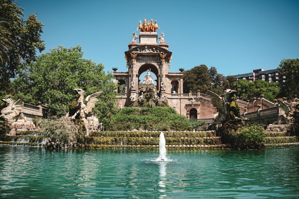 a fountain in a park surrounded by trees